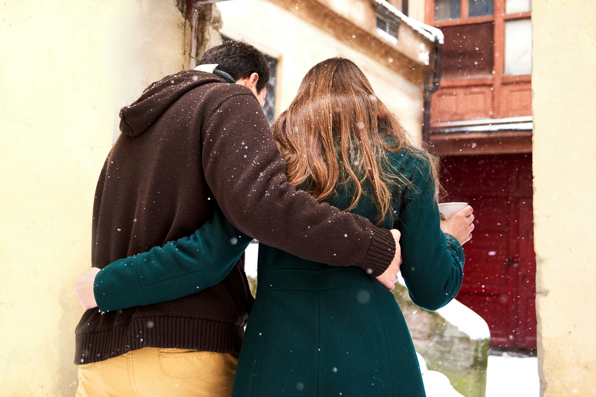 loving couple dressed in casual style walk at the old city in winter and find old abandoned yard